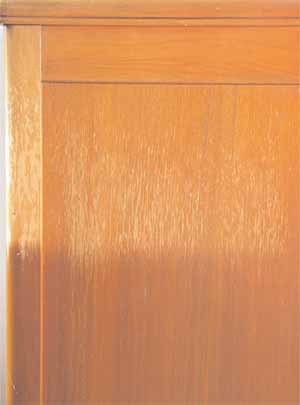 The backside of this walnut cabinet sat next to a west-facing window for ten years. The finish is peeling and the color is faded where the sunlight hit.
